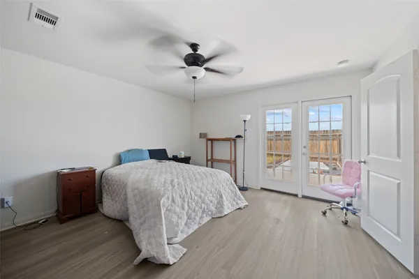 a bed room with a bed and a chair