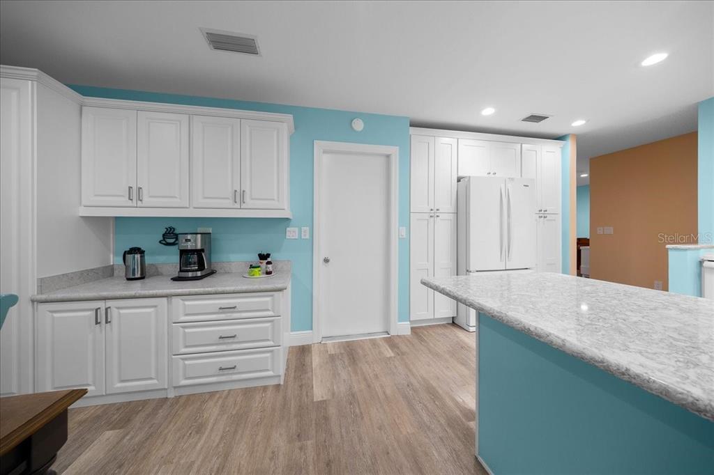 8720 Southwest 90th Street, Unit A Ocala, FL 34481 - Photo 23 of 71 a kitchen with granite countertop a sink and cabinets