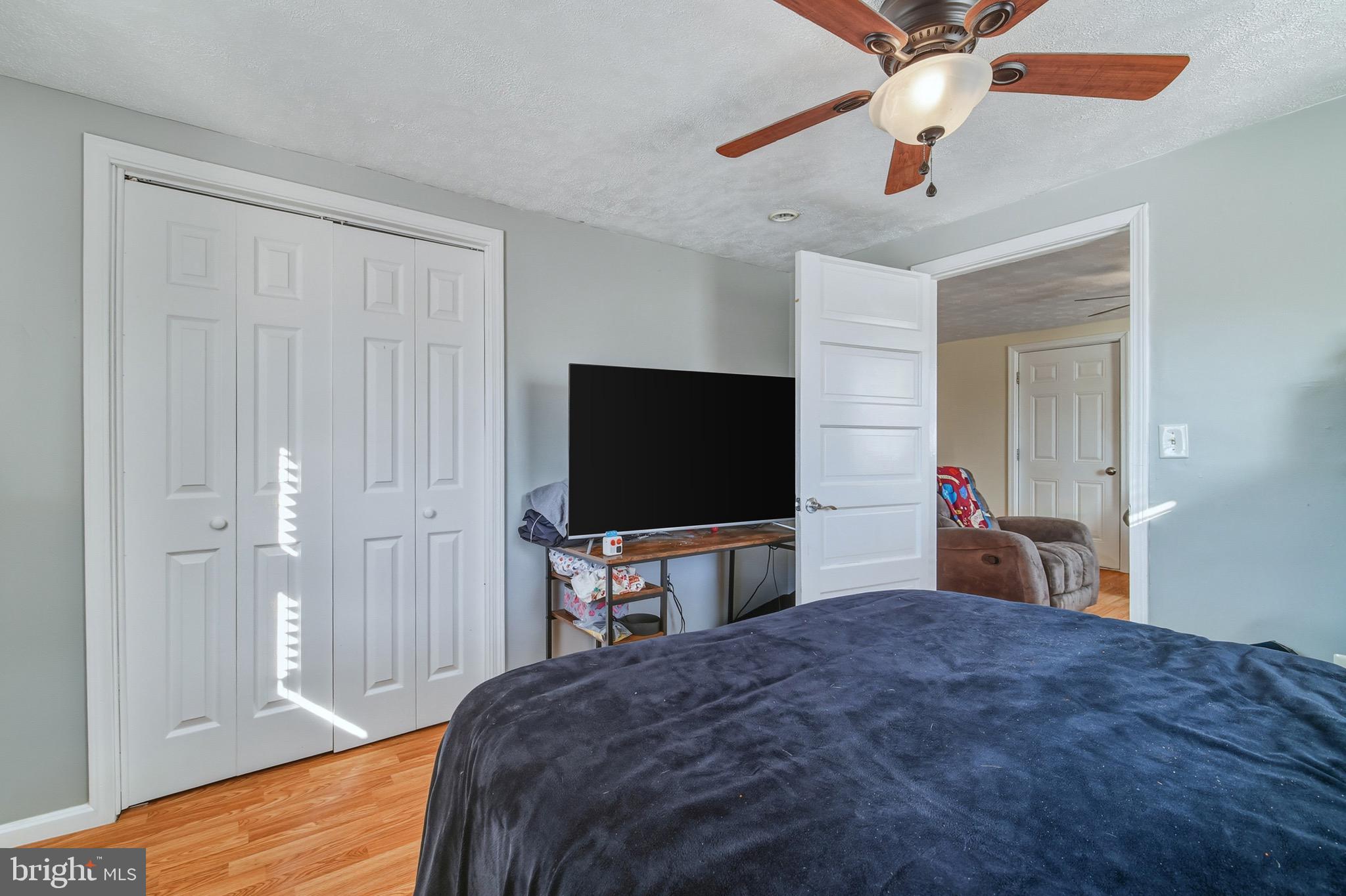 353 Turkey Knob Road Quicksburg, VA 22847 - Photo 12 of 35 a bedroom with a bed and a flat tv screen on dresser