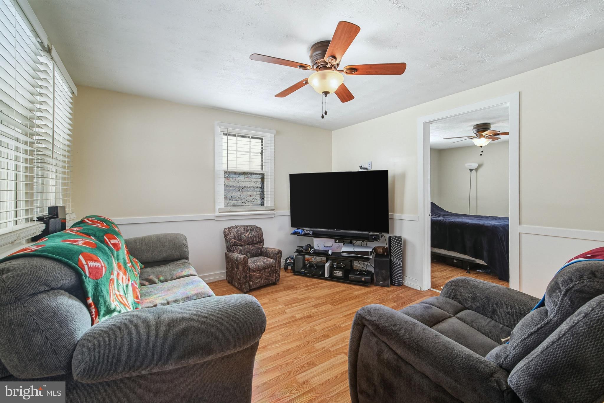 353 Turkey Knob Road Quicksburg, VA 22847 - Photo 4 of 35 a living room with furniture and a flat screen tv