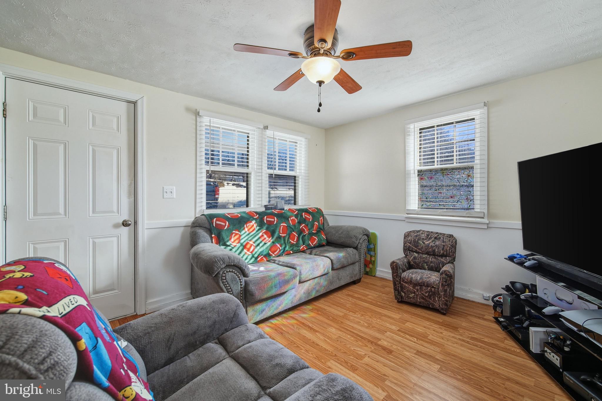 353 Turkey Knob Road Quicksburg, VA 22847 - Photo 5 of 35 a living room with furniture ceiling fan and a window