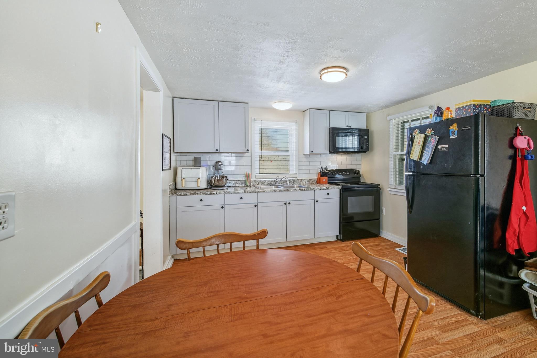 353 Turkey Knob Road Quicksburg, VA 22847 - Photo 7 of 35 a kitchen with stainless steel appliances granite countertop a refrigerator sink and cabinets