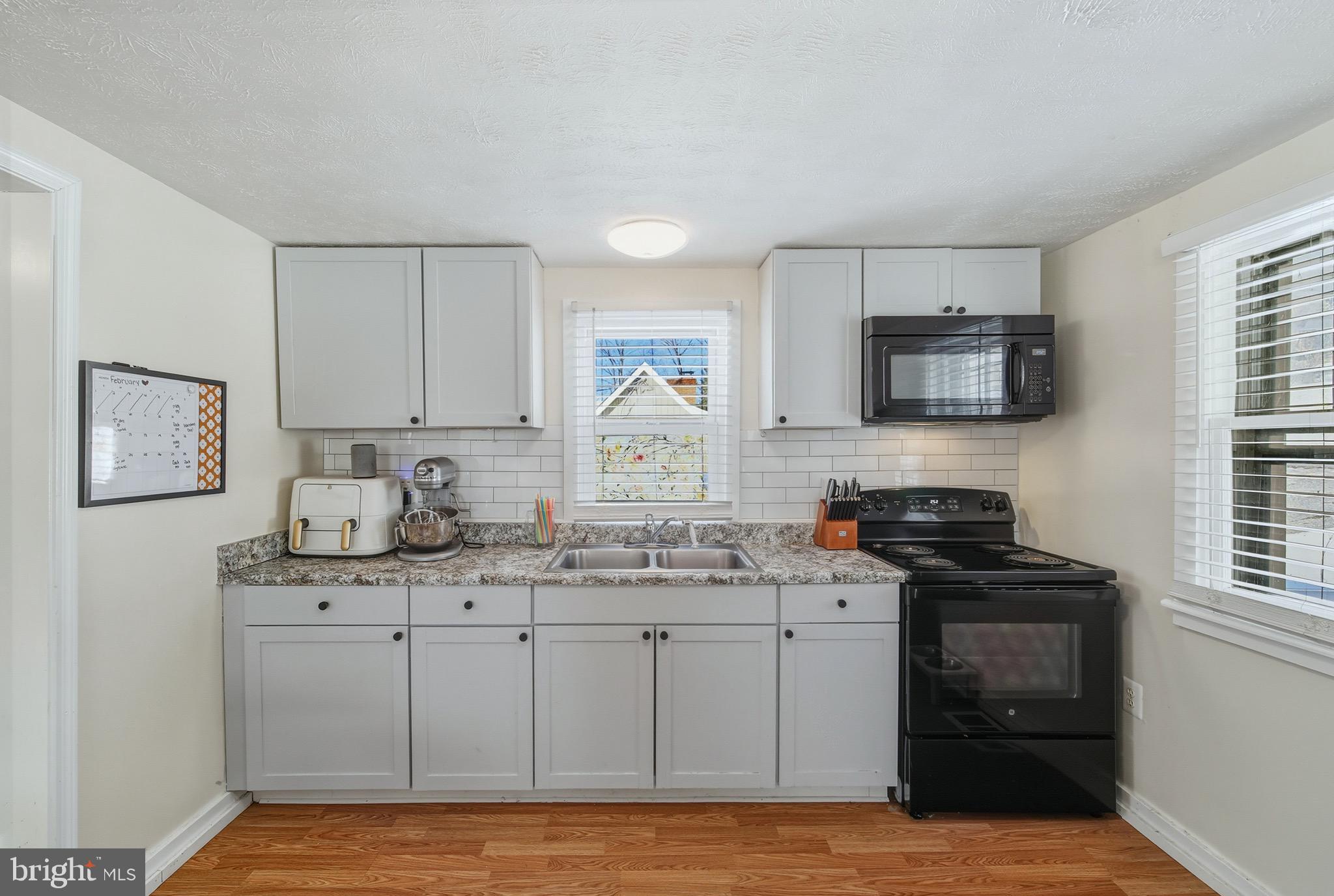 353 Turkey Knob Road Quicksburg, VA 22847 - Photo 9 of 35 a kitchen with stainless steel appliances granite countertop a sink stove and cabinets