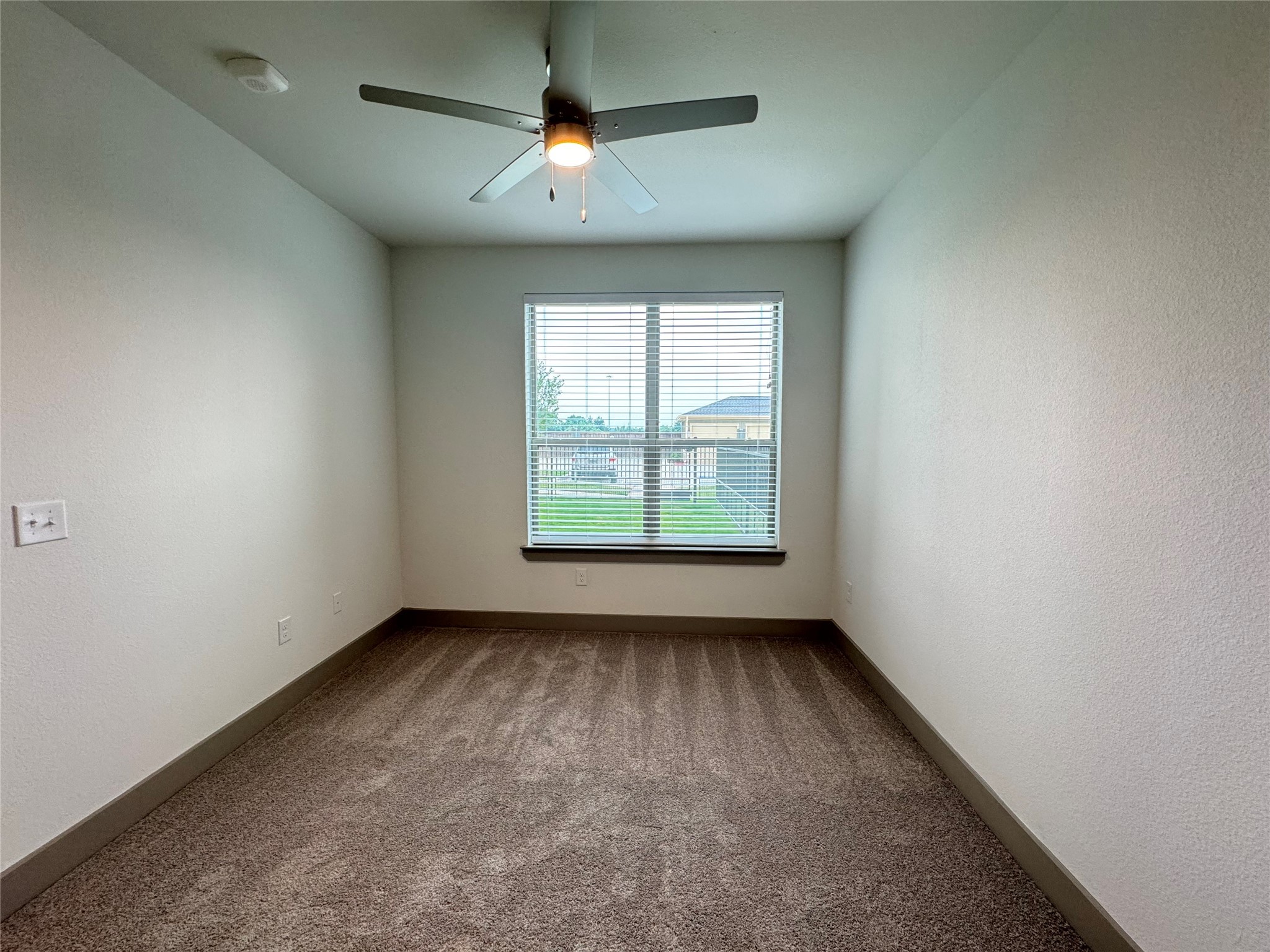 20102 Cypress Rosehill Road, Unit A1 1Y Tomball, TX 77377 - Photo 4 of 8 an empty room with a window and a fan
