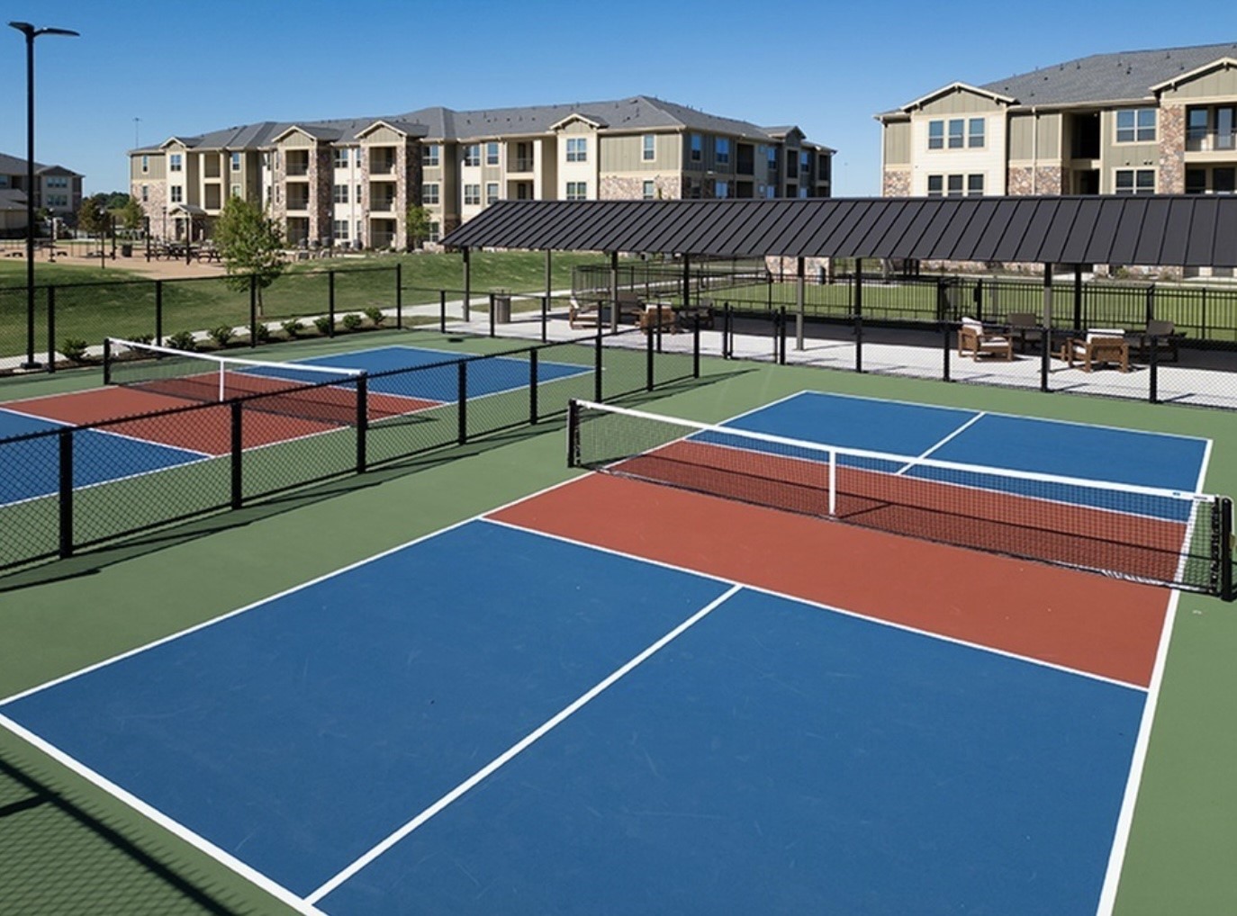 20102 Cypress Rosehill Road, Unit A1 1Y Tomball, TX 77377 - Photo 7 of 8 a view of a tennis ground with large trees