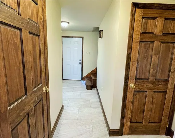 a view of a closet with wooden floor