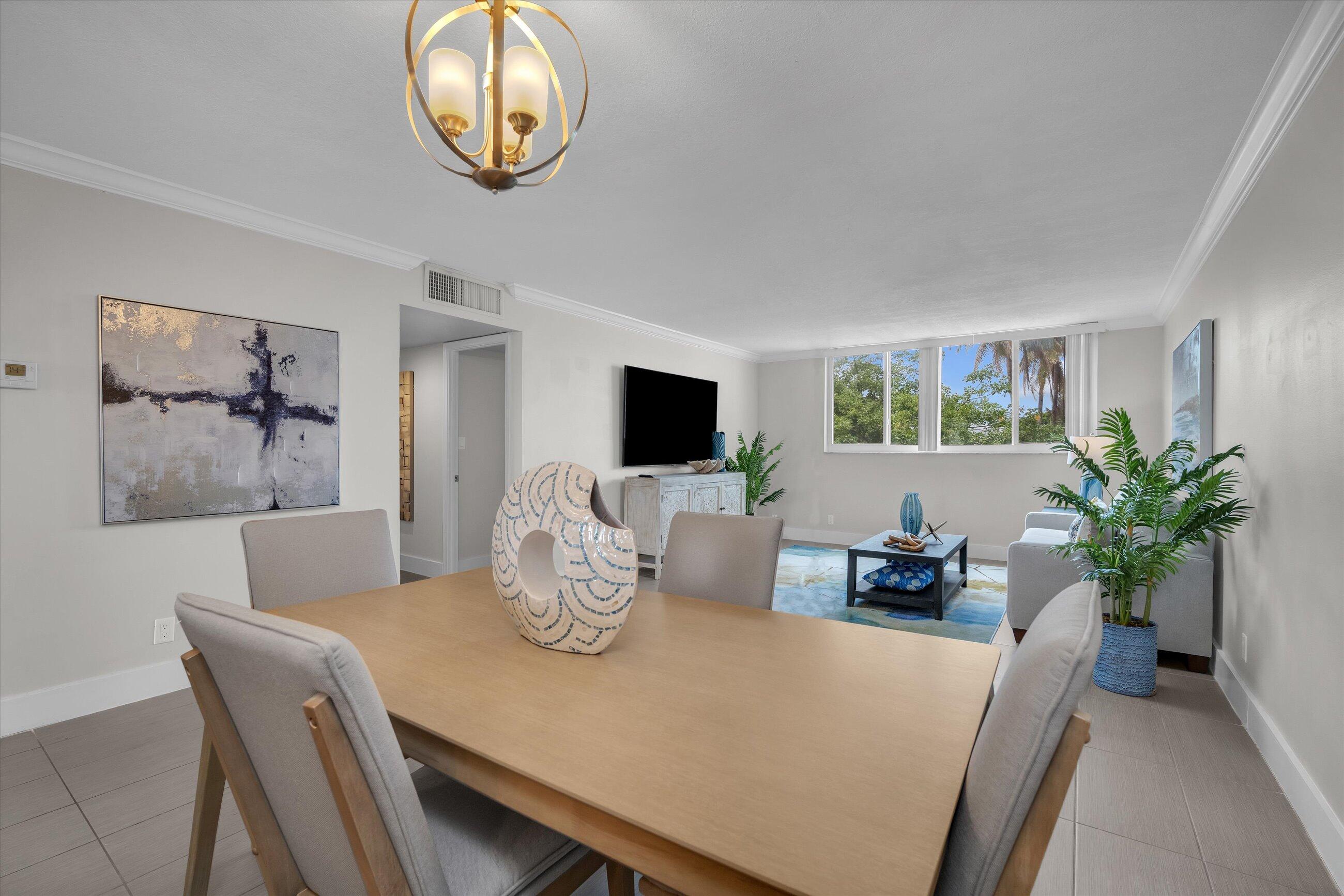 601 North Ocean Boulevard, Unit 203 Boca Raton, FL 33432 - Photo 8 of 20 a view of a dining room with furniture and a potted plant