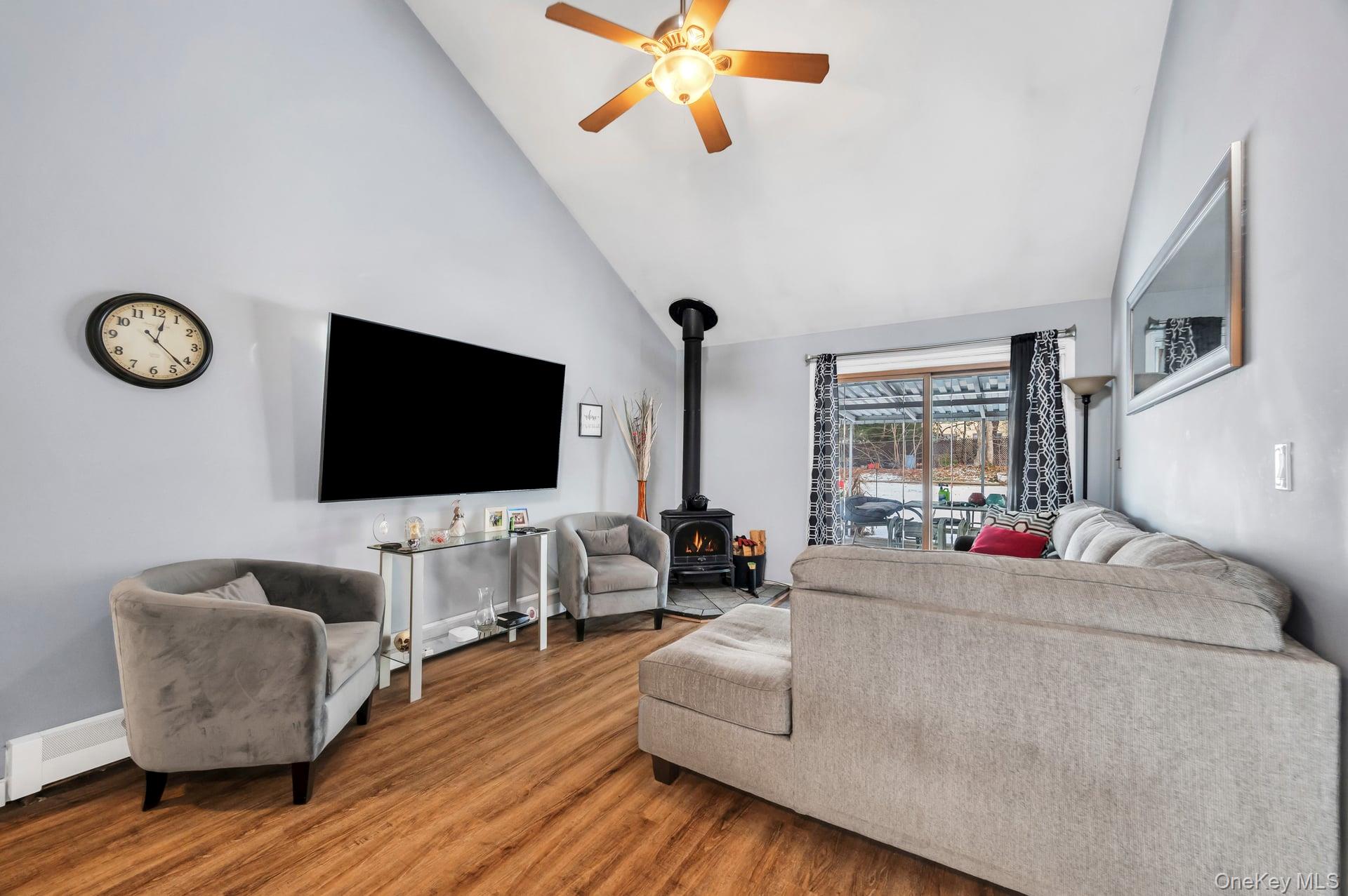 17 Groton Lane Coram, NY 11727 - Photo 11 of 34 a living room with furniture and a flat screen tv