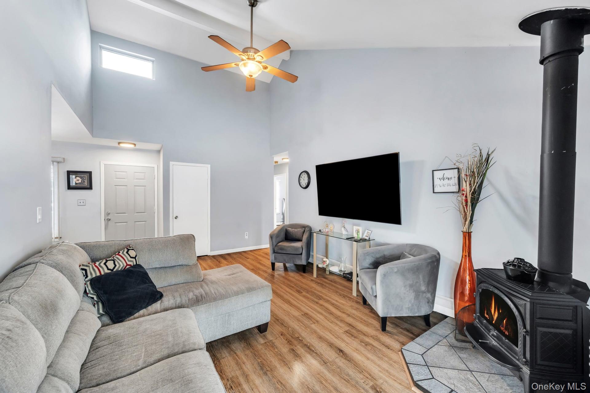 17 Groton Lane Coram, NY 11727 - Photo 12 of 34 a living room with furniture and a flat screen tv