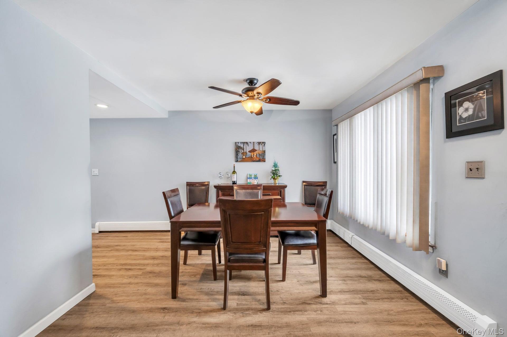 17 Groton Lane Coram, NY 11727 - Photo 13 of 34 a view of a dining room with furniture window and wooden floor