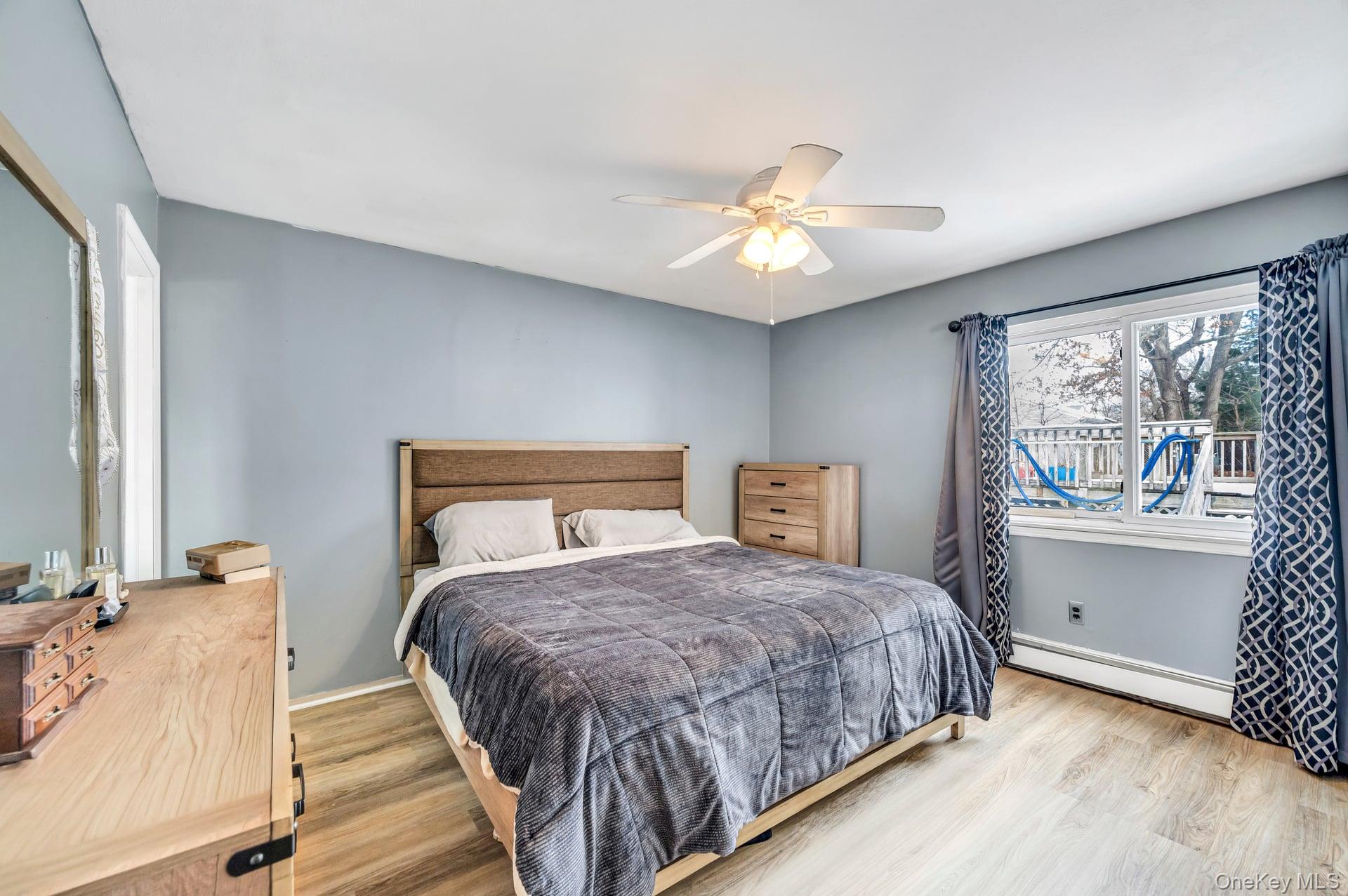 17 Groton Lane Coram, NY 11727 - Photo 19 of 34 a bedroom with a large bed and a chandelier