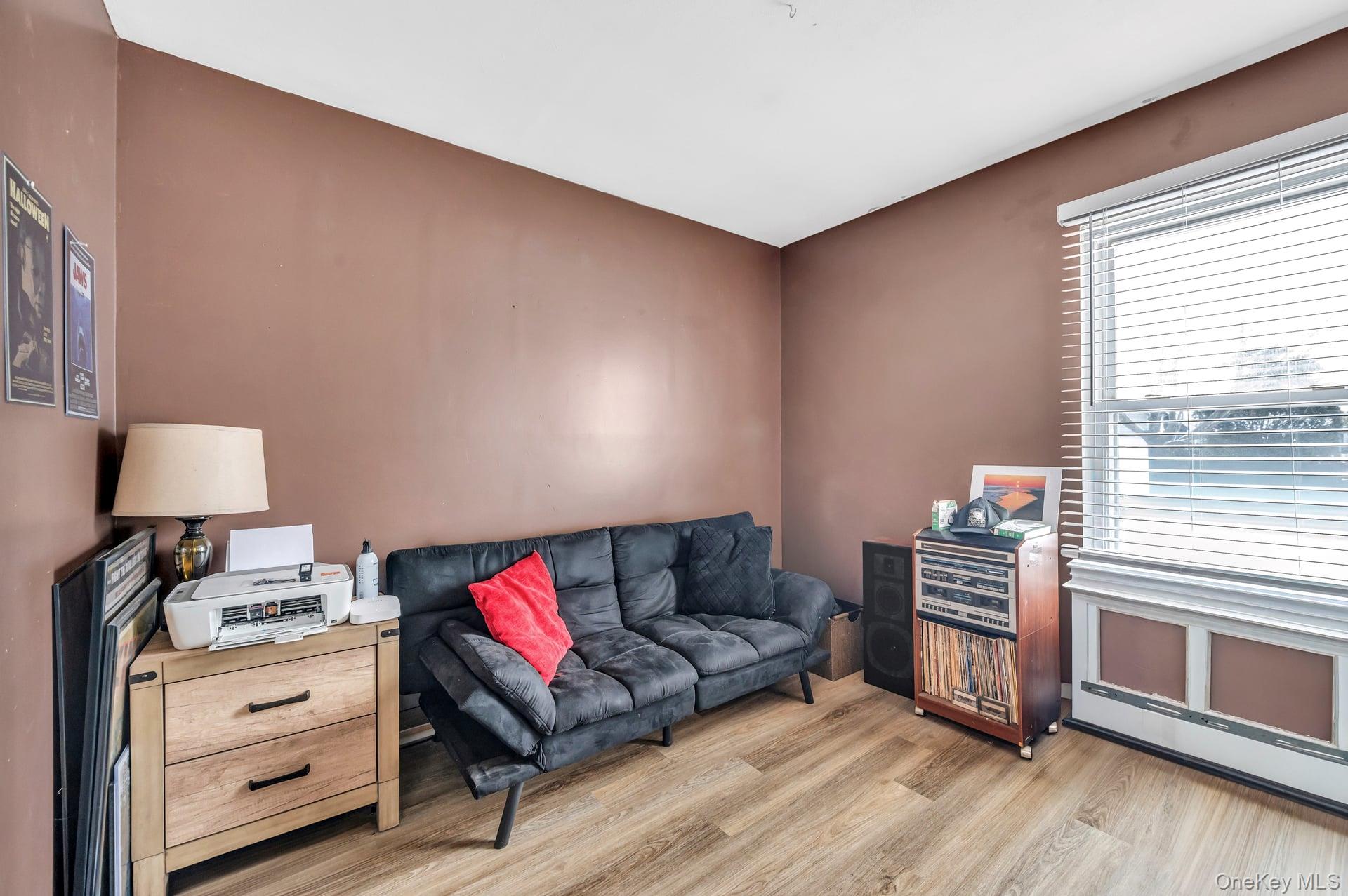 17 Groton Lane Coram, NY 11727 - Photo 22 of 34 a living room with furniture and a lamp