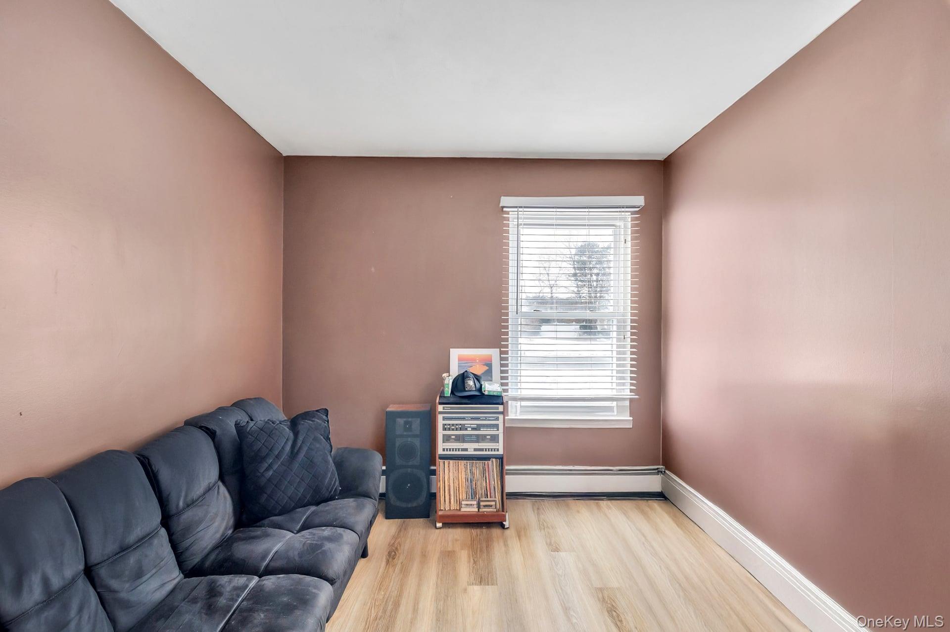 17 Groton Lane Coram, NY 11727 - Photo 23 of 34 a living room with furniture and a window
