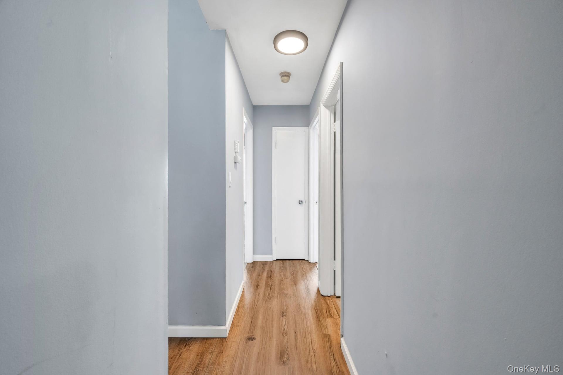 17 Groton Lane Coram, NY 11727 - Photo 25 of 34 a view of a hallway with wooden floor