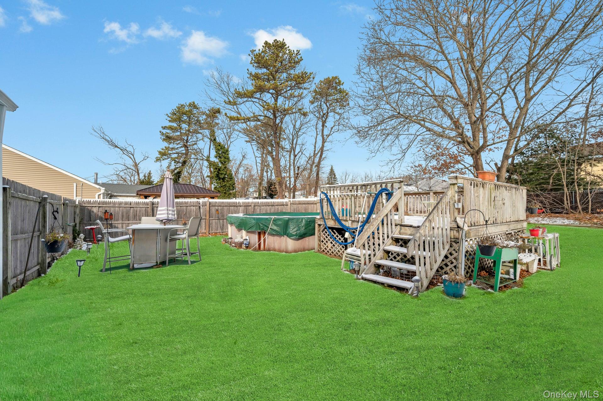 17 Groton Lane Coram, NY 11727 - Photo 32 of 34 a view of a chair and table in backyard of the house