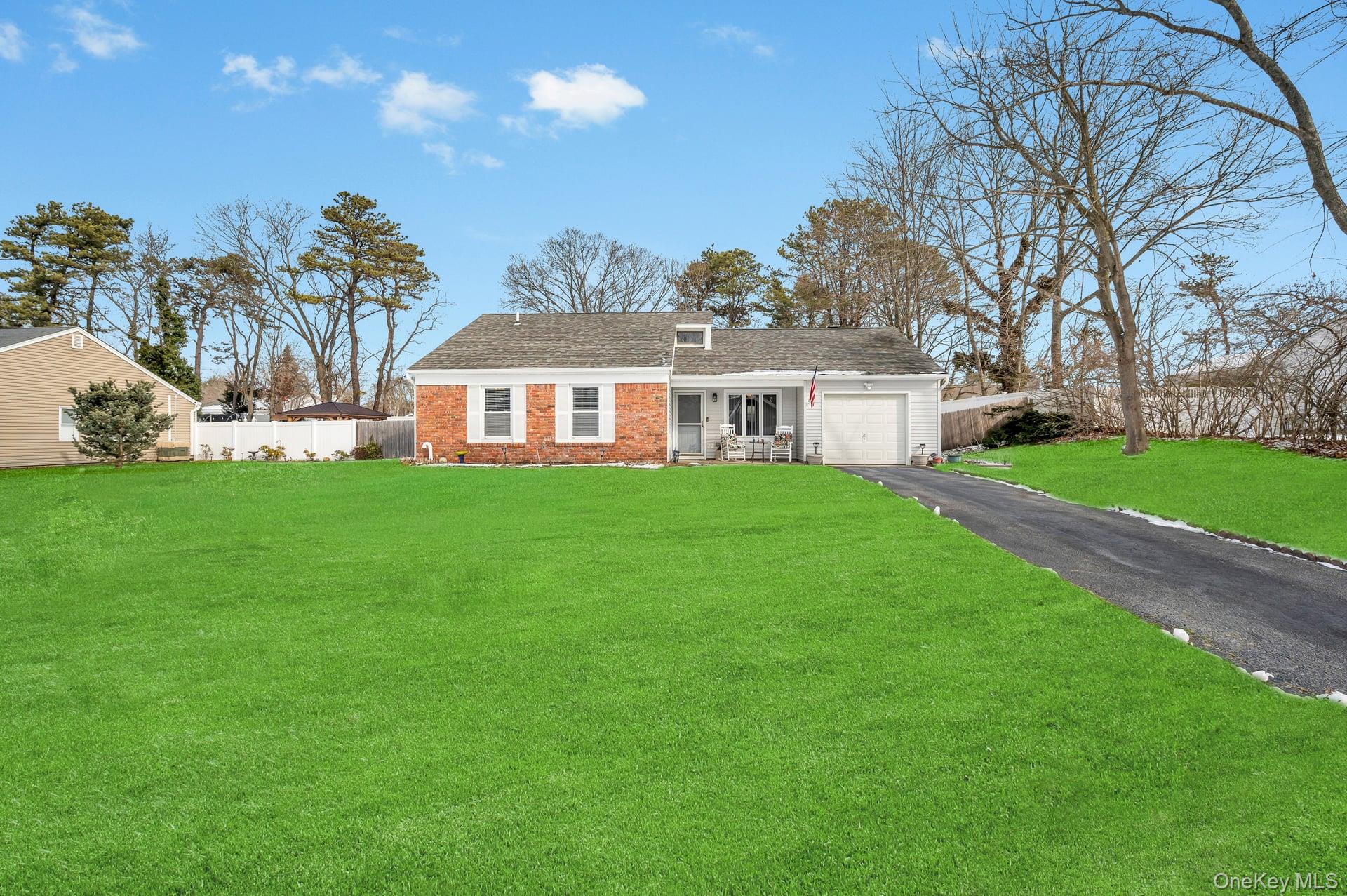 17 Groton Lane Coram, NY 11727 - Photo 7 of 34 a view of a house next to a big yard and large trees