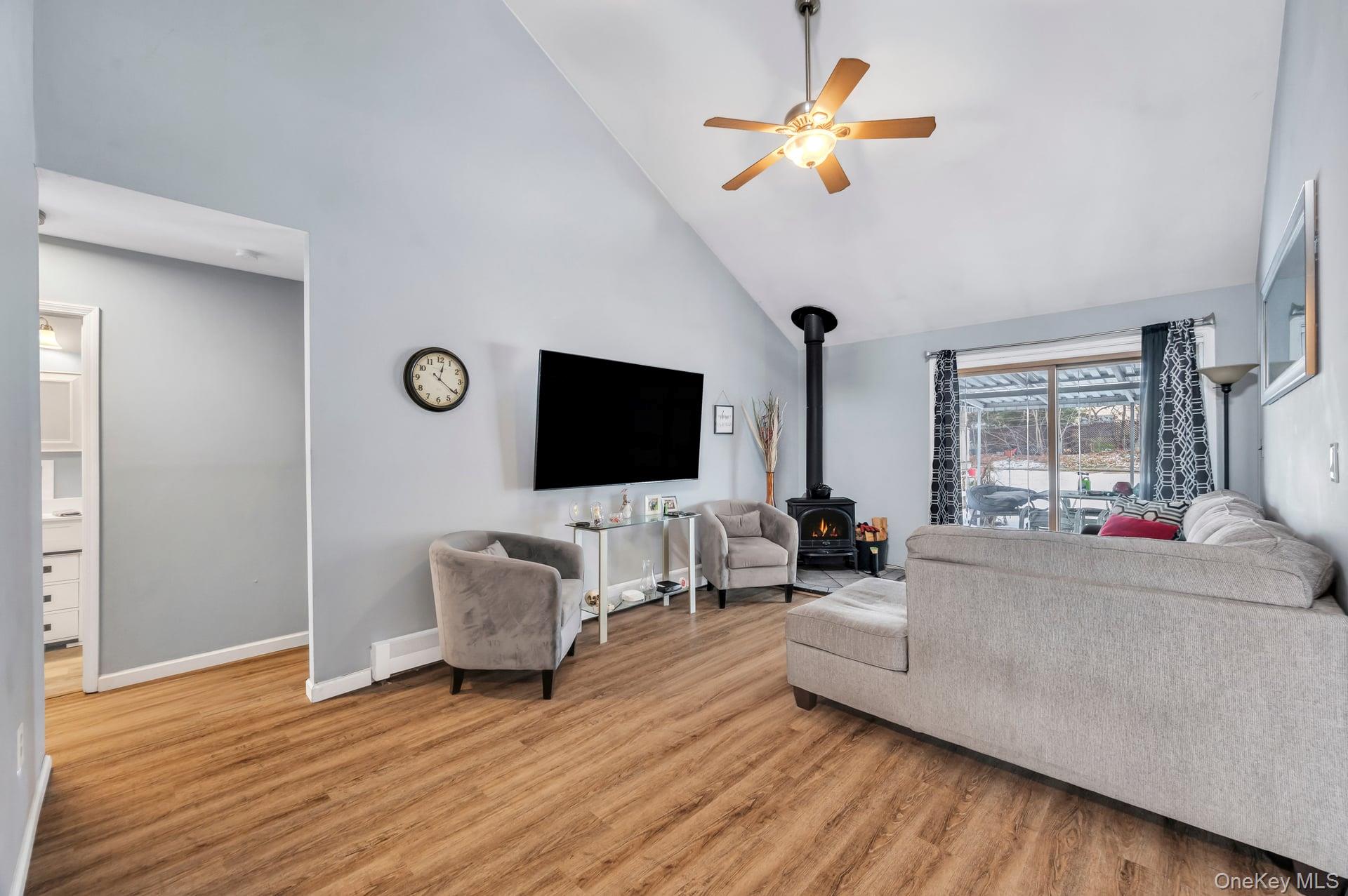 17 Groton Lane Coram, NY 11727 - Photo 9 of 34 a living room with furniture fireplace and a flat screen tv