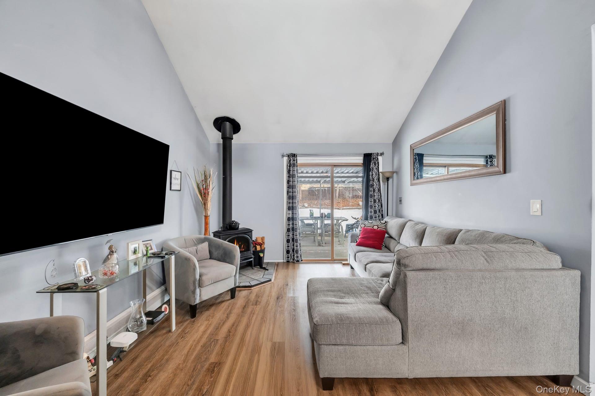 17 Groton Lane Coram, NY 11727 - Photo 10 of 34 a living room with furniture and a flat screen tv