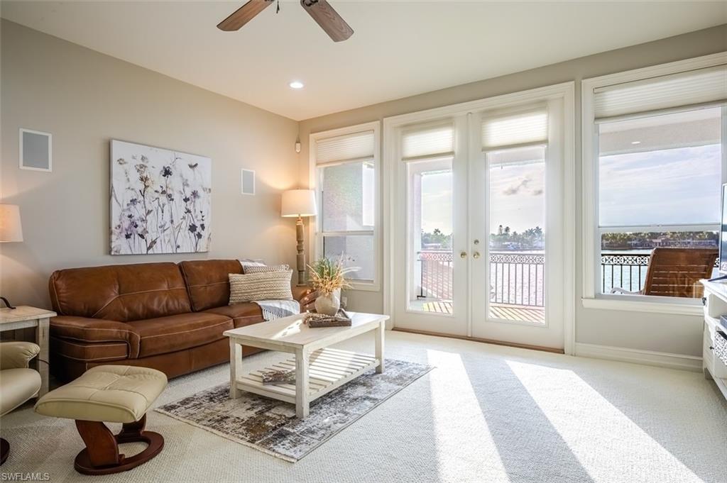 1942 Kingfish Road Naples, FL 34102 - Photo 35 of 43 a living room with furniture and a large window