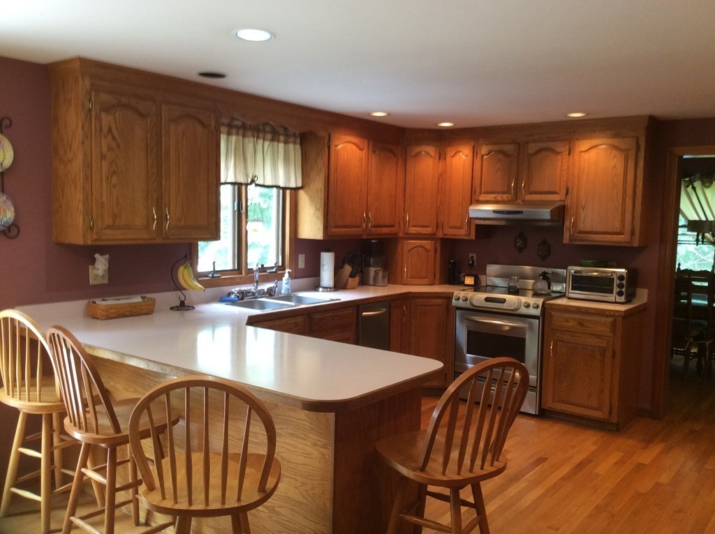 51 Allen Road Billerica, MA 01821 - Photo 2 of 24 a kitchen with stainless steel appliances granite countertop a stove a sink dishwasher a microwave oven with granite countertops and cabinets