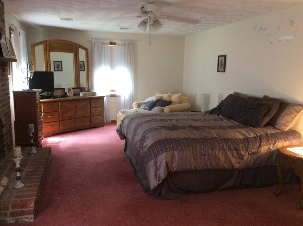 51 Allen Road Billerica, MA 01821 - Photo 9 of 24 a bedroom with a bed and a dresser in it