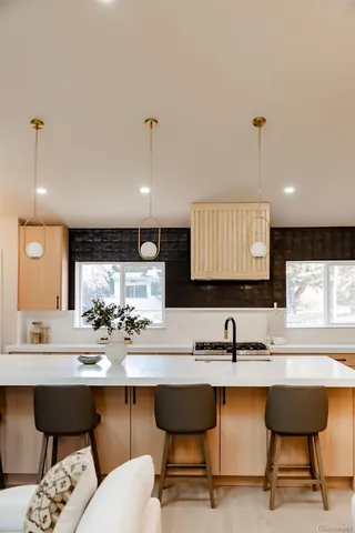 a kitchen with a sink and chairs