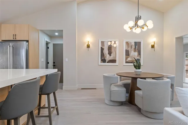 a view of a dining room with furniture and chandelier