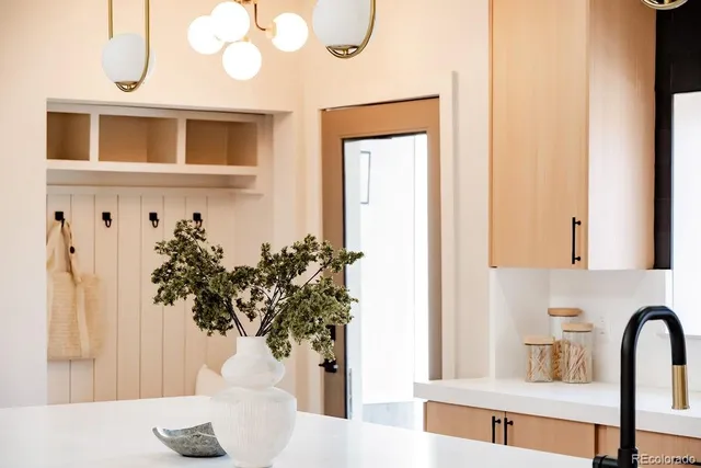 a vase of flowers sitting on a table with a mirror