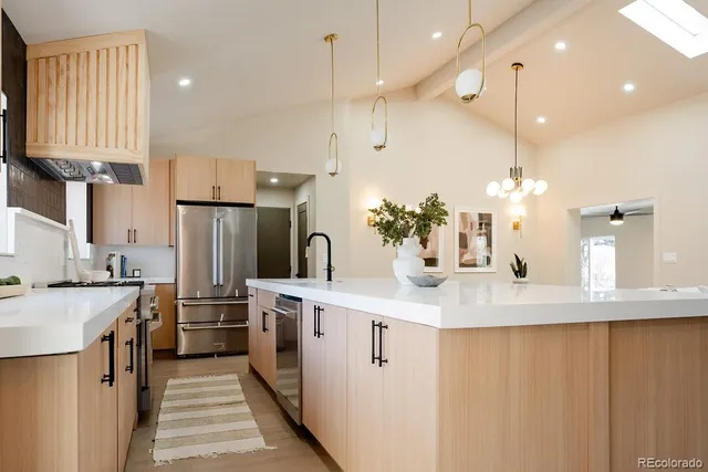 a kitchen with kitchen island a sink appliances and cabinets