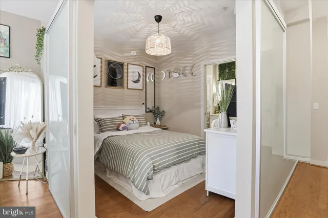 a bedroom with a bed and a chandelier