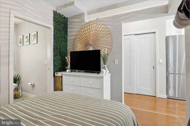 a bedroom with a bed and a flat screen tv