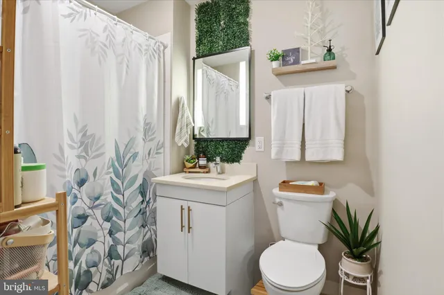 a bathroom with a toilet a sink and a mirror