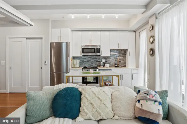 a kitchen with stainless steel appliances a refrigerator and a stove top oven