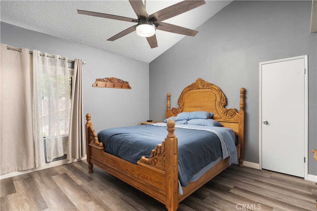 1000 Olive Drive, Unit 40 Bakersfield, CA 93308 - Photo 13 of 16 a bedroom with a bed and wooden floor