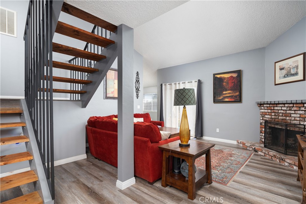 1000 Olive Drive, Unit 40 Bakersfield, CA 93308 - Photo 9 of 16 a living room with furniture a fireplace and a large window