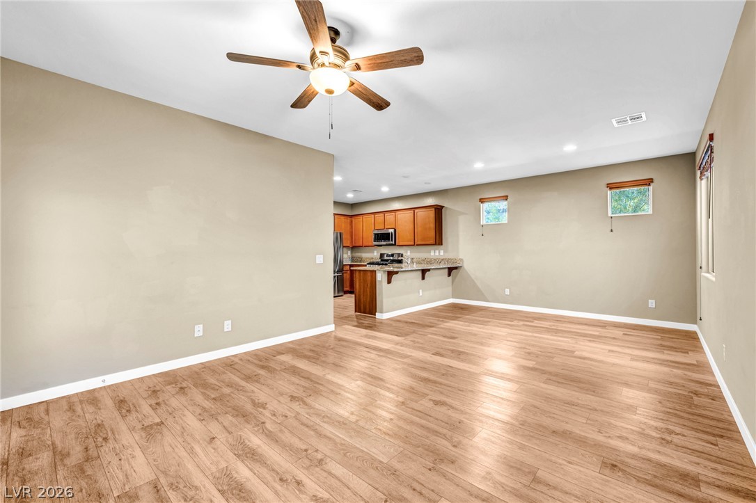 5014 Fiery Sky Ridge Street Las Vegas, NV 89148 - Photo 6 of 21 An open-concept living space with natural light and elegant flooring.