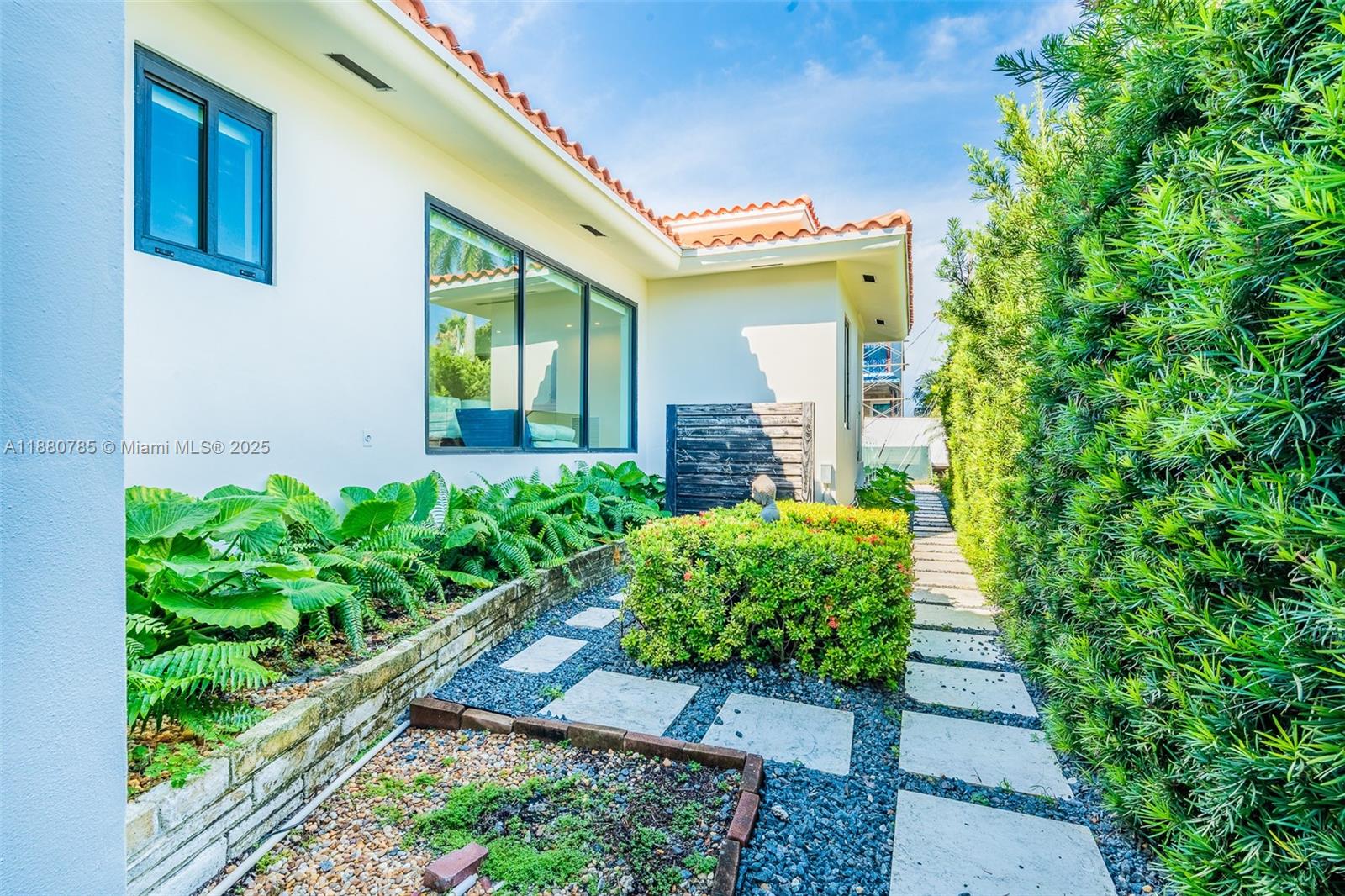 12905 Cherry Road North Miami, FL 33181 - Photo 13 of 22 a front view of a house with garden