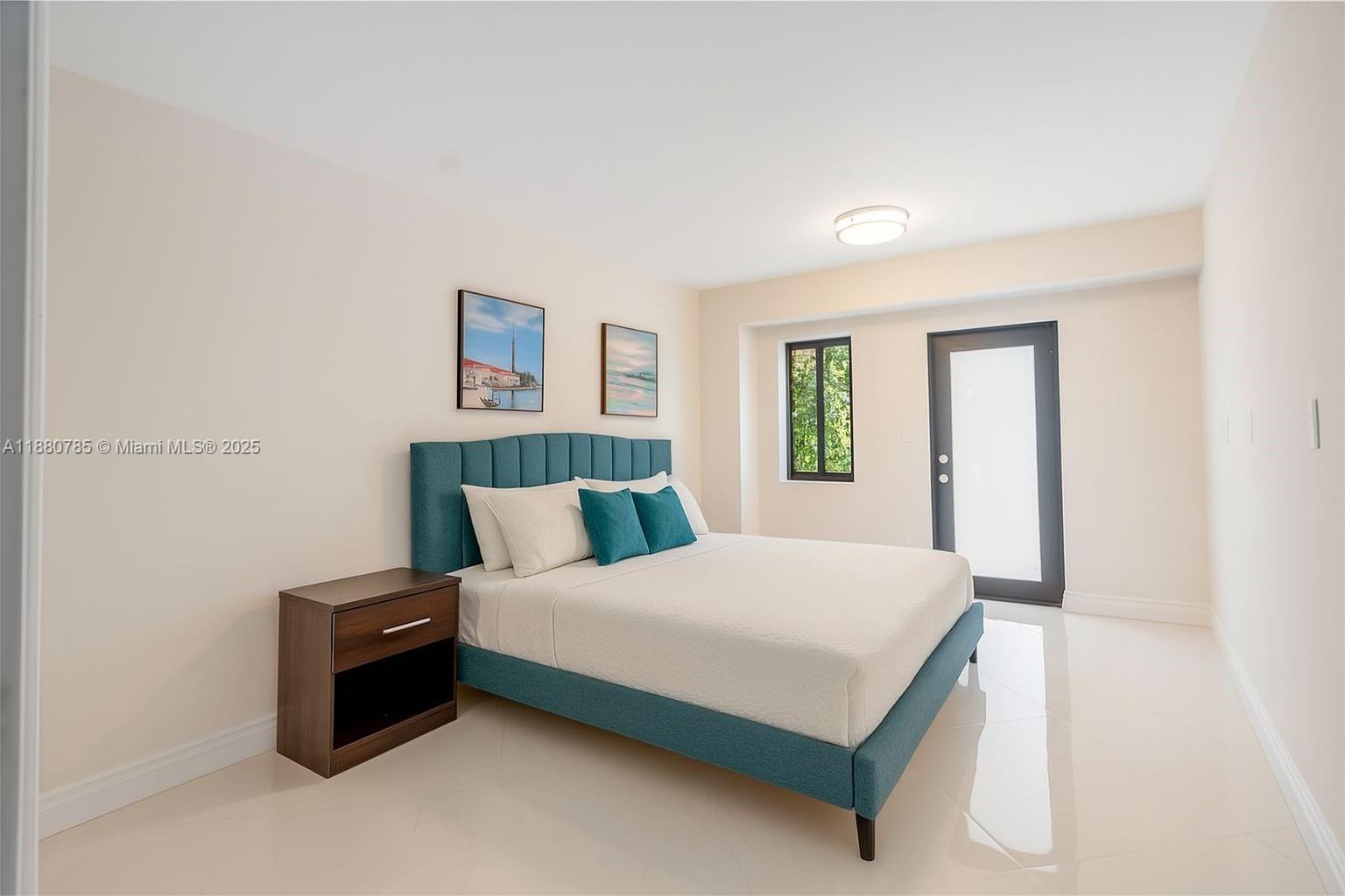 12905 Cherry Road North Miami, FL 33181 - Photo 21 of 22 a bedroom with a bed and a couch