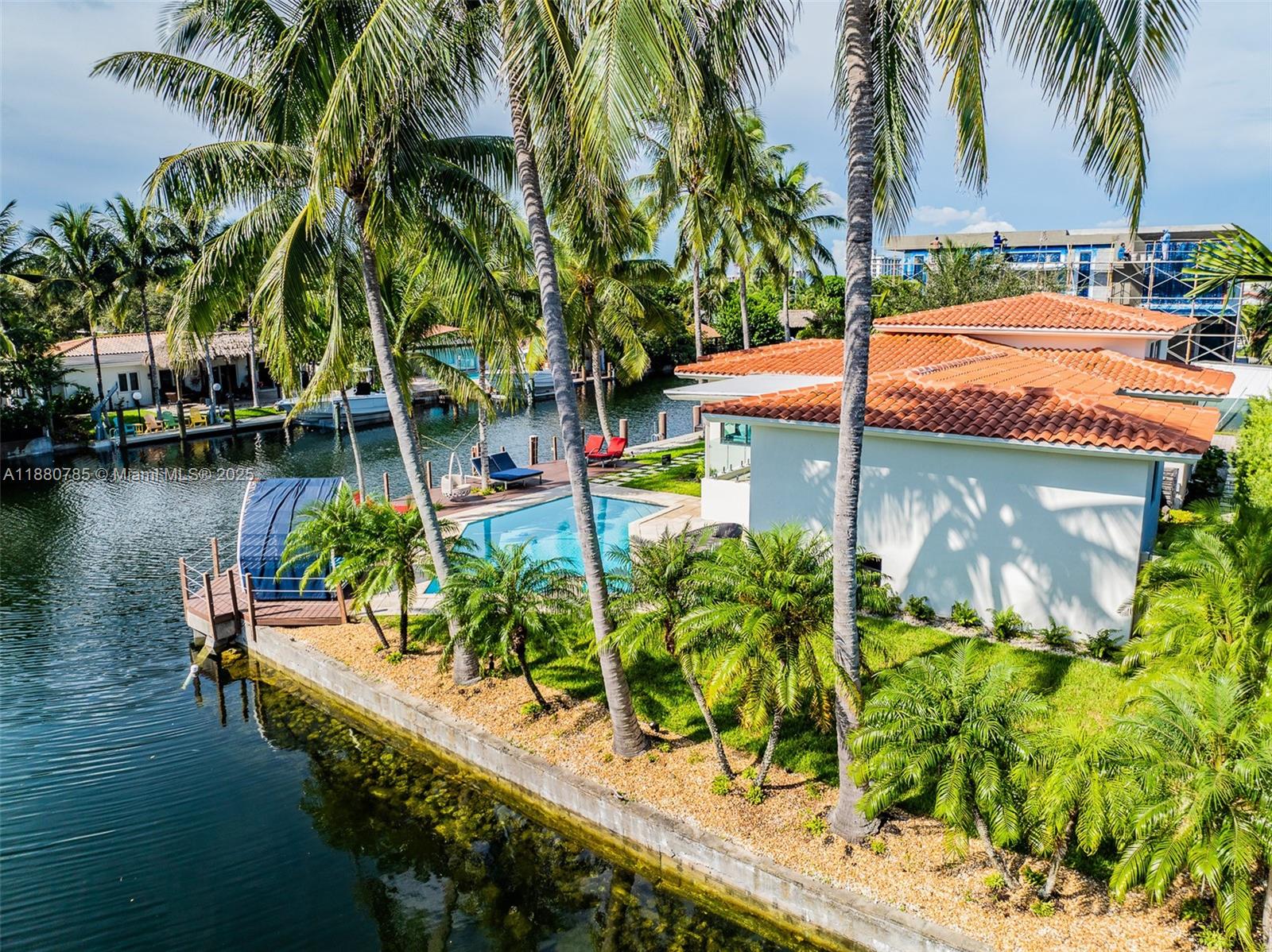12905 Cherry Road North Miami, FL 33181 - Photo 3 of 22 a view of a swimming pool with a patio