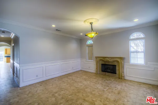 an empty room with fireplace and windows