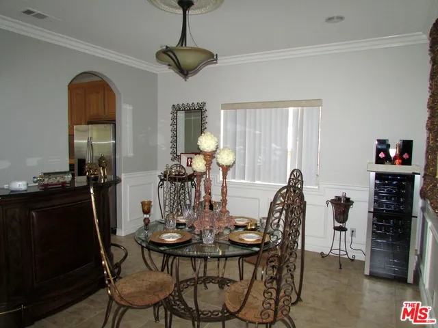 a large kitchen with stainless steel appliances granite countertop a large window and a counter space