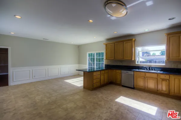 a kitchen with stainless steel appliances granite countertop a sink and cabinets