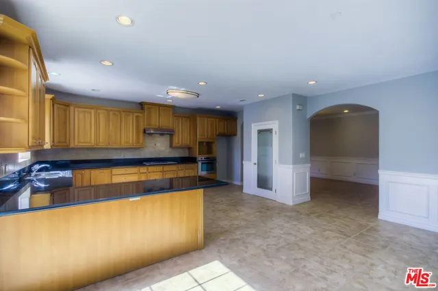 a bathroom with a granite countertop sink a toilet a mirror and shower