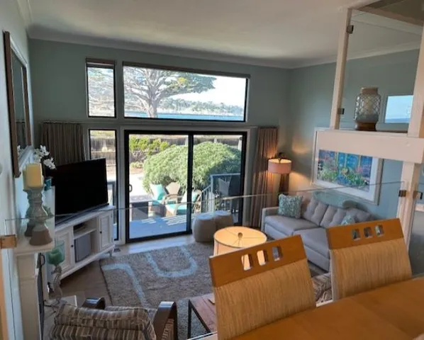 a kitchen with stainless steel appliances granite countertop a stove top oven a sink a dining table and chairs