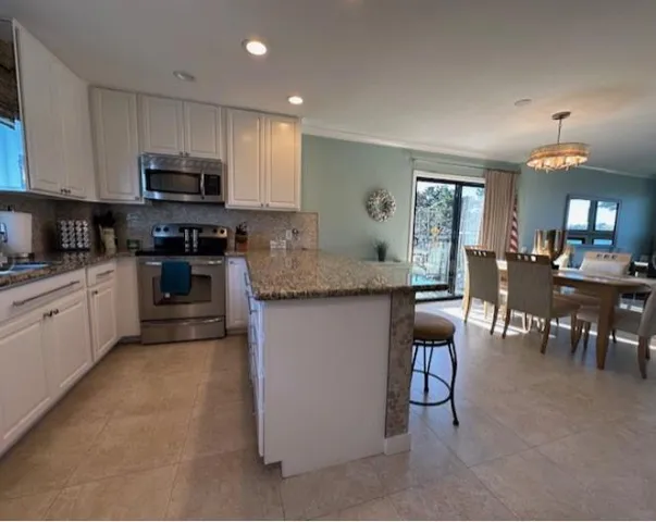 a large bedroom with a bed and a television