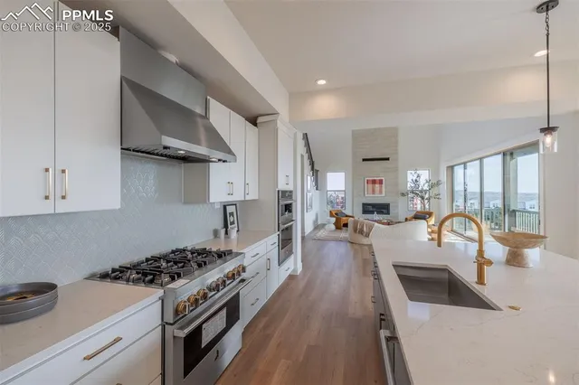 a kitchen with sink a stove and cabinets