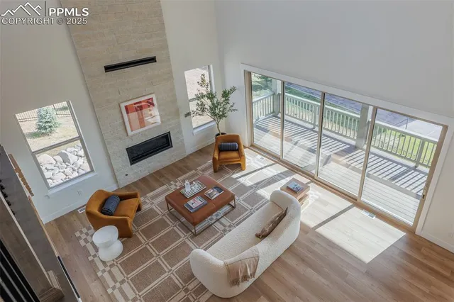 a living room with furniture and floor to ceiling windows