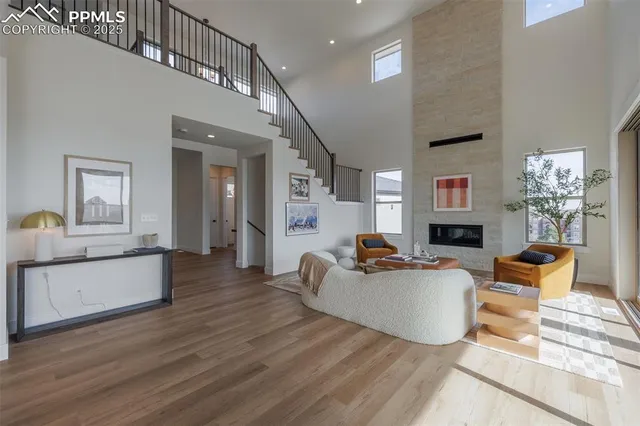 a living room with fireplace furniture and a wooden floor