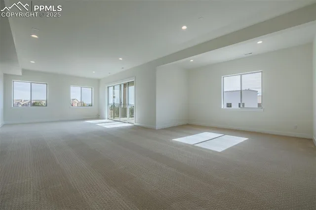 an empty room with windows and closet