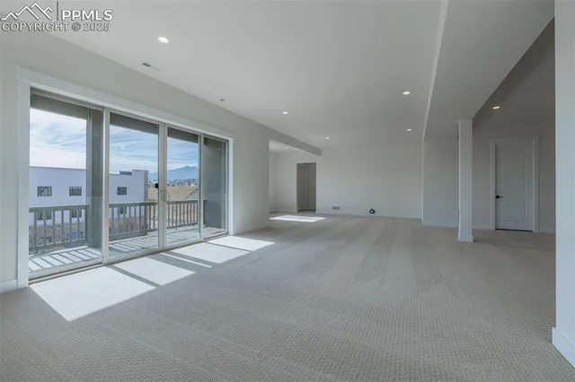 a view of an empty room with a sliding door